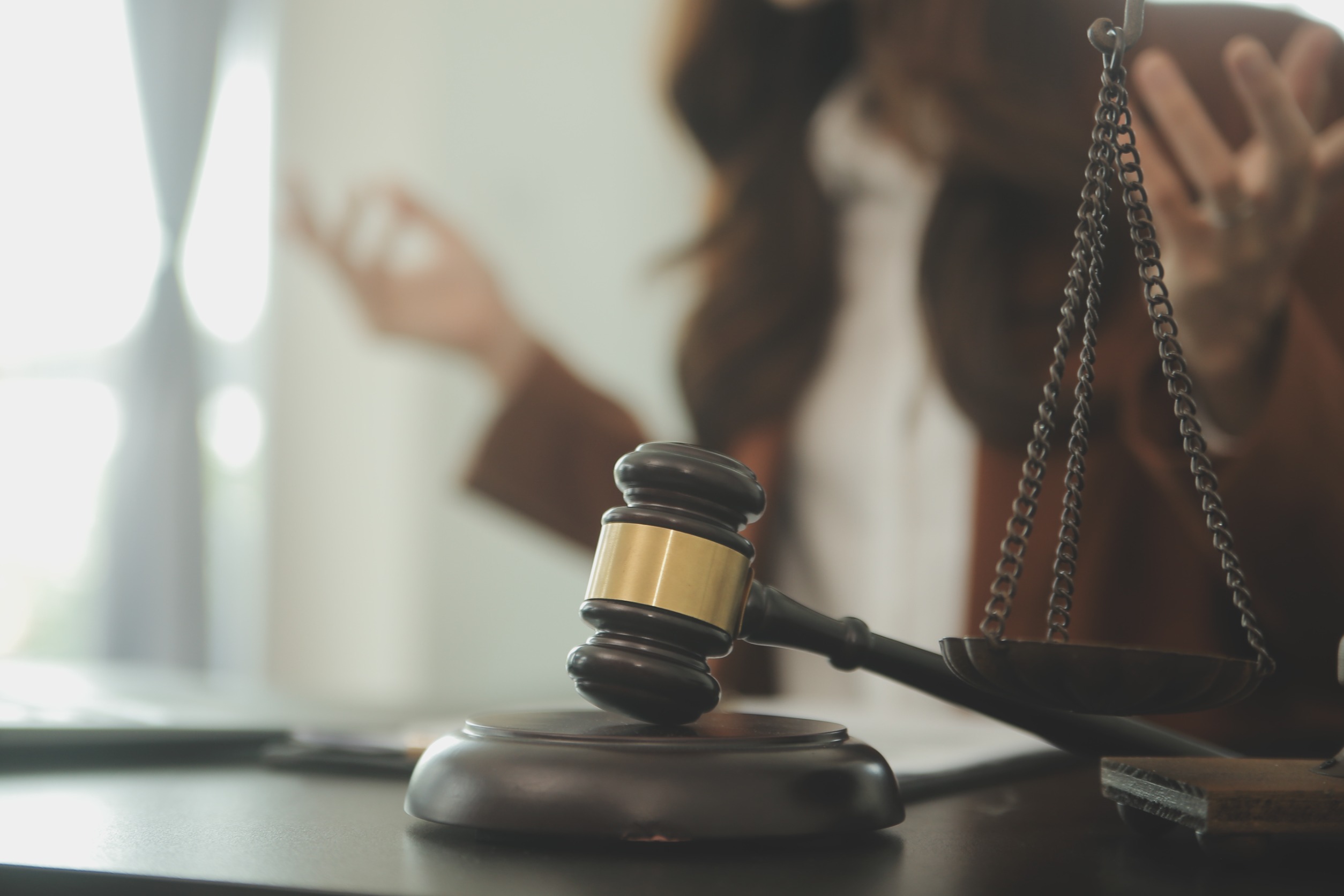 Lawyer hitting a gavel on her desk.